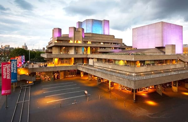 Exterior view of the National Theatre in Pretoria, featuring its iconic helmet-shaped design against a clear blue sky.